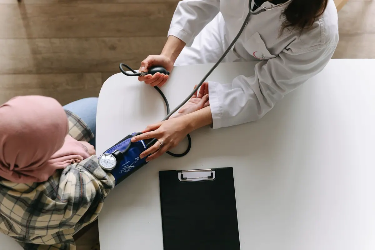 A doctor taking a patient's blood pressure